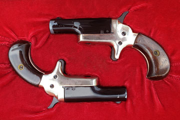 antique pistols on a red velvet background