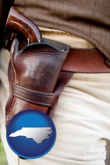 north-carolina map icon and a gun in a Western-style, leather holster