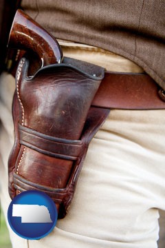 a gun in a Western-style, leather holster - with Nebraska icon