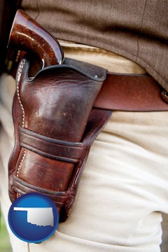 a gun in a Western-style, leather holster - with Oklahoma icon