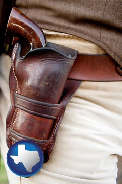 a gun in a Western-style, leather holster - with Texas icon